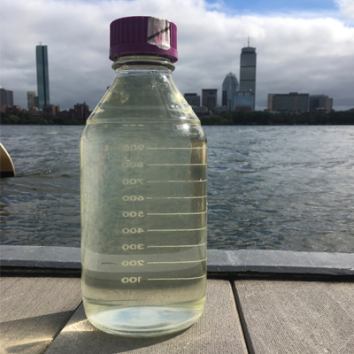 Glass bottle in front of river