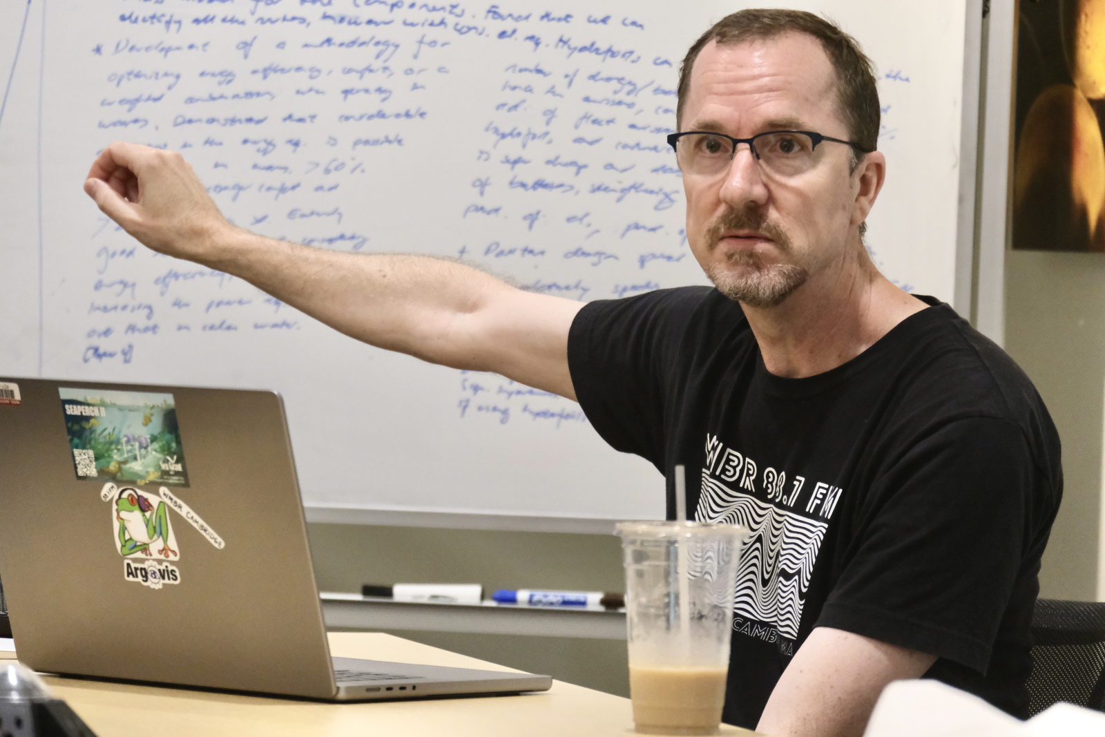 Ben Bray giving a presentation in a conference room setting