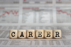 wooden cubes with the word career on them in front of a financial graph stock photo