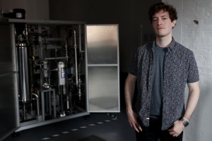 Peter Godart next to equipment in the company’s workshop