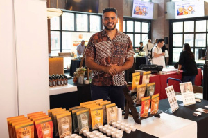 Joshua Reed-Diawuoh at a food fair selling bags of Gria cashews.