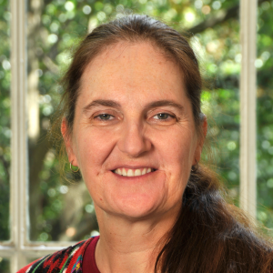 Older woman with brown hair smiles