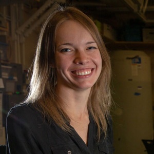 Woman with straight blonde hair smiling for camera